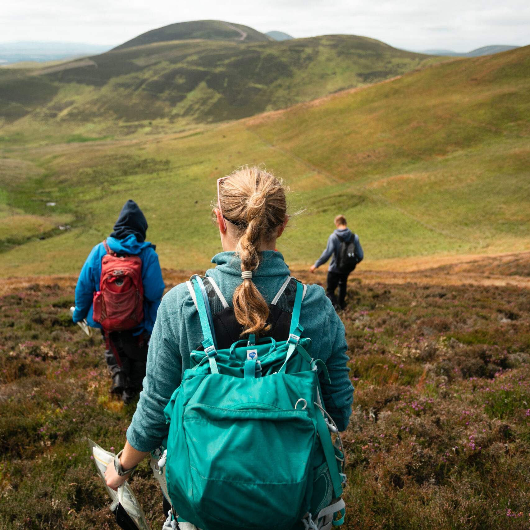 A group of people walking in the Scottish hills